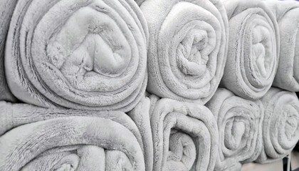 Rolled gray blankets  in store for sale.