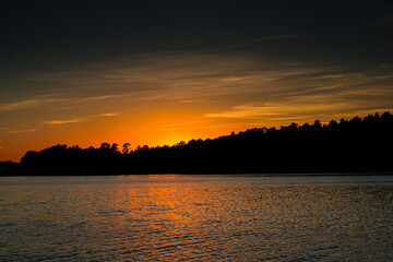Sunset over the forest lake
