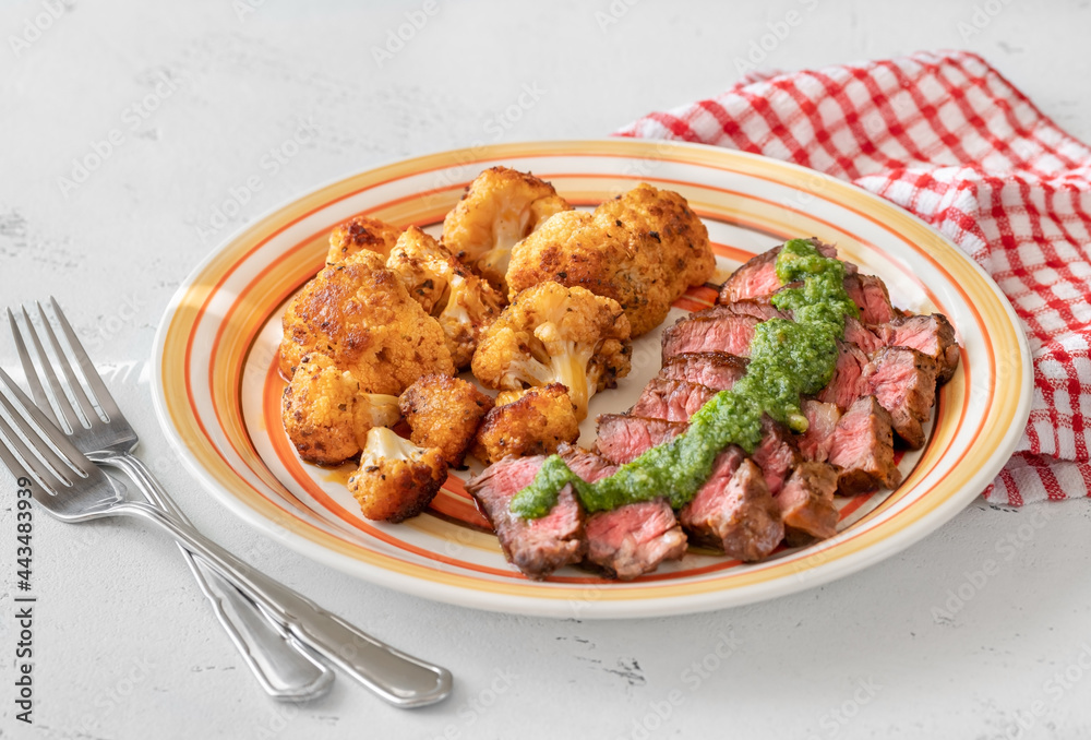 Wall mural sliced beef steak with baked cauliflower