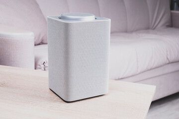 electronic equipment smart speaker on the table in the room and houseplant