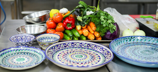 Fresh vegetables and empty cooking utensils