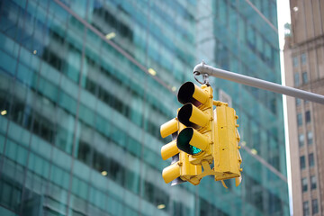 Yellow Traffic Light on background of skyscrapers, Manhattan, New York, USA.