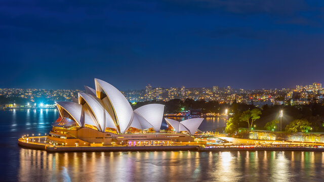 Sydney, New South Wales, Australia, 5 July, 2021 ; The Sydney Opera House and skyline illuminated at night.