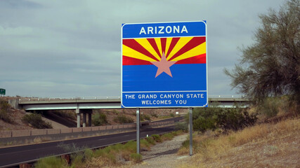 Welcome to Arizona road sign on the State border Route, US. The grand canyon state welcomes you. - 443487933