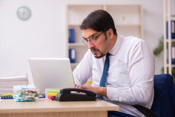 Fototapeta premium Young male bookkeeper in budget planning concept