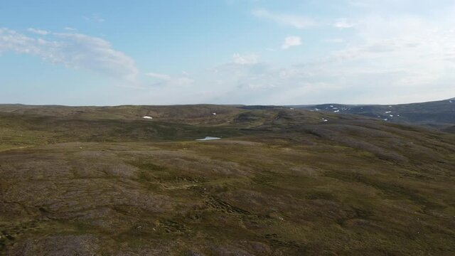 flying over the mighty plains of the mageroy island in Nordkapp, north cape, county in summer, aerial overview shot