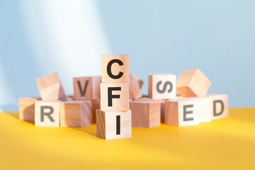 CFI written on wooden cubes, yellow background