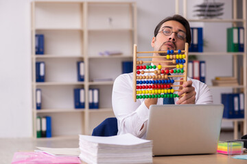 Young male bookkeeper in budget planning concept holding abacus - obrazy, fototapety, plakaty
