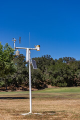 Weather environment instrument against a blue sky
