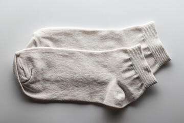 Pair of white socks on white background
