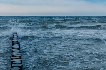 Fototapeta premium rough waves in the baltic sea, breakwater on the coast.