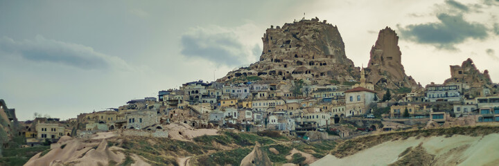 Obraz premium Uchisar cave town. Uchisar castle in Cappadocia valley in Turkey goreme. Wide banner photo