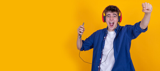 teen boy with headphones and mobile phone isolated