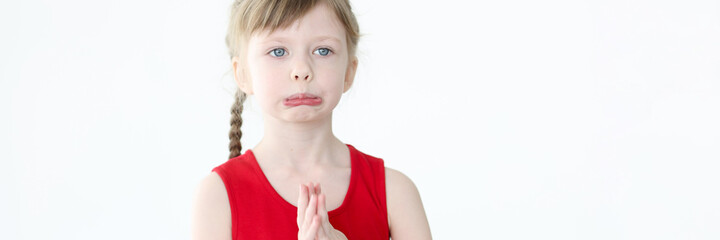 Portrait of little offended girl with blue eyes