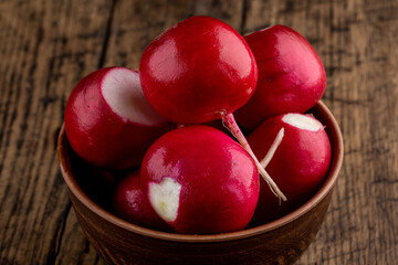 fresh red radish at on a rustic table top