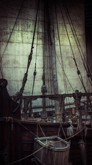 Old pirate ship with sail and mast as gloomy vintage retro background