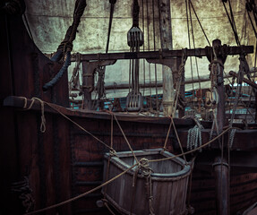 Old pirate ship with sail mast and ropes as gloomy vintage retro background