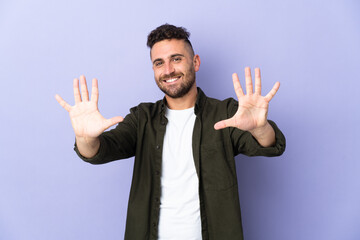 Caucasian man isolated on purple background counting ten with fingers
