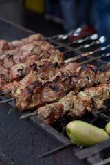 Grilled skewers of meat on the coals, with smoke. street food.