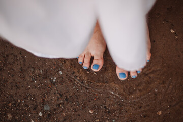 the concept of coolness and connection with nature after a hard day, grounding barefoot in the water. 