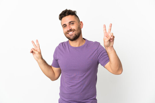Caucasian man isolated on white background showing victory sign with both hands
