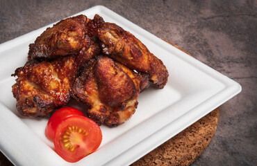 Spicy BBQ chicken wings. Roasted chicken on a plate.