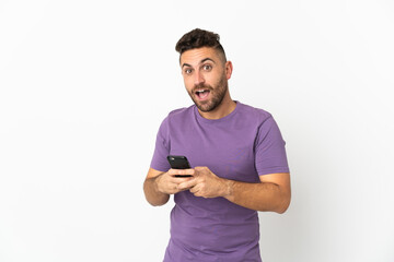 Caucasian man isolated on white background surprised and sending a message