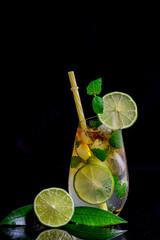 Refreshing summer mojito cocktail with ice cubes, fresh mint and lime