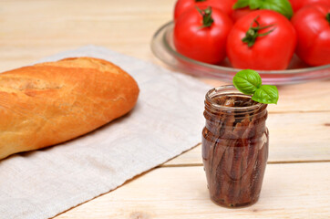 a jar of anchovies and other products on the table