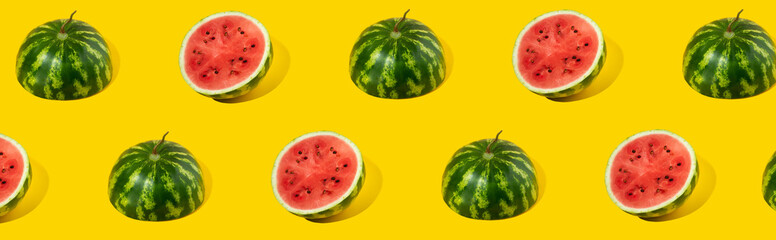 Pattern of sliced fresh watermelon on yellow background. Summer fruit, berry. Bold color. Trendy, Minimal shadows. Watermelon day concept -3 august.