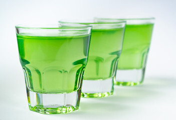 Sweet dessert, green fruit jelly in glass glasses on a white background