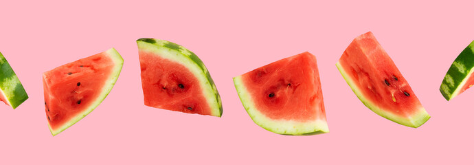 Floating, levitating sliced fresh watermelon on pink background. Summer fruits, berries. Trendy,minimal Creative food. Concept of watermelon day-August 3.