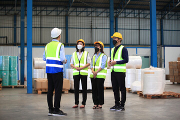Team workers wear protective face masks for safety industrial factory. worker meeting before start working in factory or warehouse