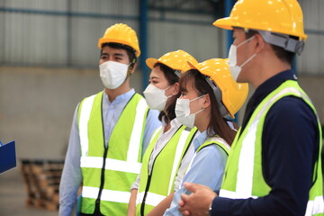 Team workers wear protective face masks for safety industrial factory. worker meeting before start working in factory or warehouse