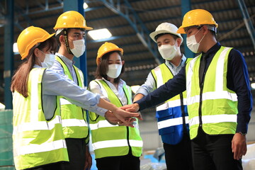 Team workers wear protective face masks for safety industrial factory. worker meeting before start...