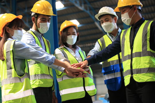 Team workers wear protective face masks for safety industrial factory. worker meeting before start working in factory or warehouse