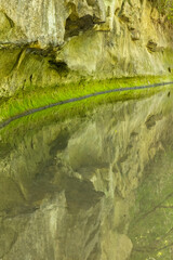 A Calm Reflective Creek and Cliff.