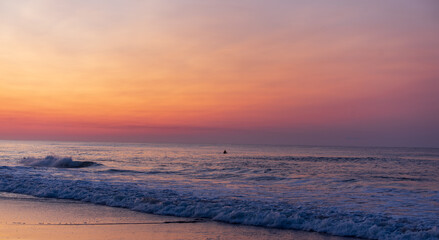 Fototapeta na wymiar Surfing at Sunrise