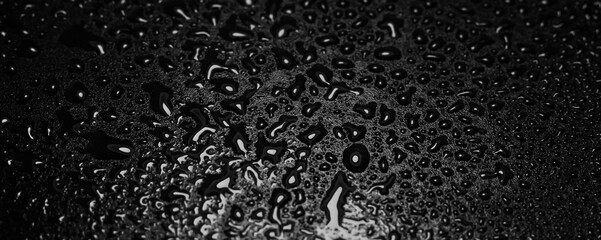 Water droplets on black background. Close-up photo of small water drops on black background for...