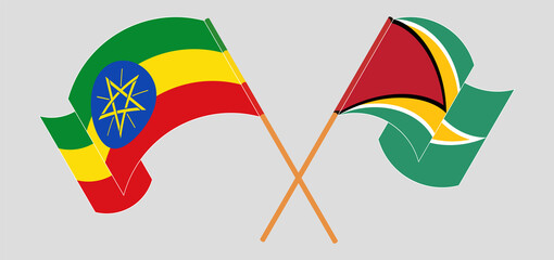 Crossed and waving flags of Ethiopia and Guyana