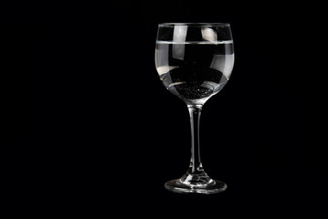 TRANSPARENT CRYSTAL BOWL ISOLATED ON BLACK BACKGROUND