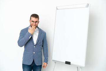 Young business woman giving a presentation on white board isolated on white background happy and smiling covering mouth with hand