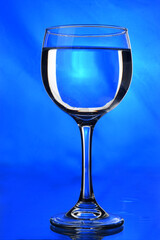 TRANSPARENT CRYSTAL BOWL ISOLATED ON BLUE BACKGROUND