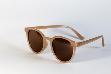 light brown sunglasses on a white background