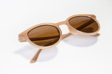 light brown sunglasses on a white background