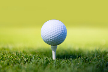 Golf ball on green course background with copy space.