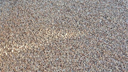 Small decorative stones. In pink or reddish colors. For indoor and outdoor areas, gardens, borders, vases, sidewalk, construction. Background, texture, banner.