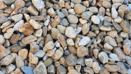 Decorative stones. Pebble. Natural river stone. For indoor and outdoor areas, garden, borders, vases, street, sidewalks, construction. Background, texture, banner. View from above.