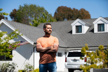 Man real estate, rental house. Portrait of confident man standing outside new home. Successful real estate agent purchasing house for investment purpose.