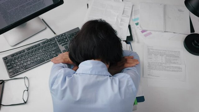 Depressed woman at office desk